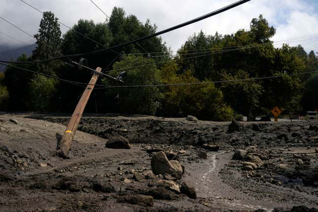 Electric poles are seen half-fallen in the aftermath of a mudslide on Tuesday, Sept. 13, 2022, in Oak Glen, California.