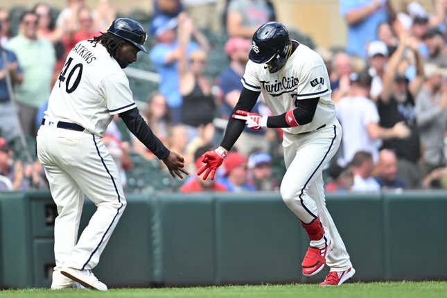 Aug 27, 2023; Minneapolis, Minnesota, USA; Minnesota Twins third baseman Royce Lewis (23) reacts with third base coach/outfield coach Tommy Watkins (40) after hitting a grand slam off Texas Rangers relief pitcher Chris Stratton (not pictured) during the sixth inning at Target Field.