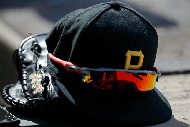 Apr 23, 2022; Chicago, Illinois, USA; A detail view of the glove, hat, and sunglasses of Pittsburgh Pirates first baseman Yoshi Tsutsugo (not pictured) during the eighth inning of their game against the Chicago Cubs at Wrigley Field.