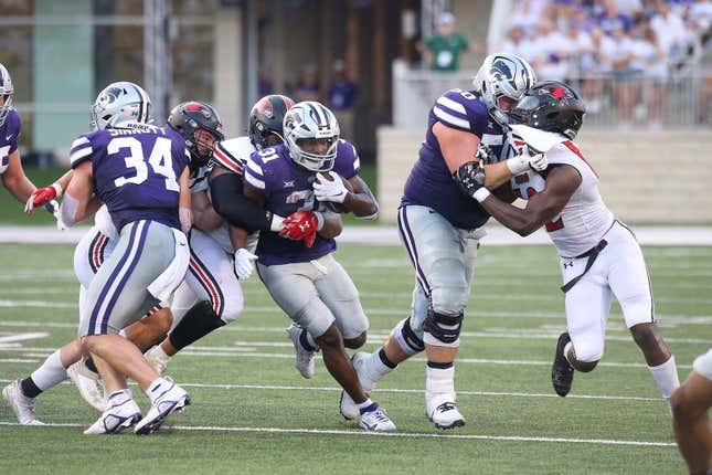 Sep 2, 2023; Manhattan, Kansas, USA; Kansas State Wildcats running back DJ Giddens (31) is tacked by Southeast Missouri State Redhawks defensive lineman LaWilliam Holmes (91) and linebacker Jacob Morrissey (44) during the second quarter at Bill Snyder Family Football Stadium.
