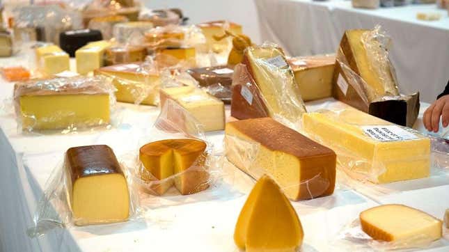 Table with various wrapped cheeses