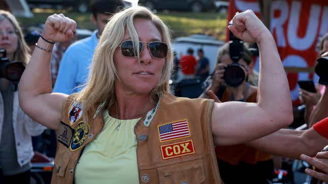 Rep. Marjorie Taylor Greene flexes during a Bikers  for Trump campaign event held at the Crazy Acres Bar &amp; Grill on May  20, 2022 in Plainville, Georgia
