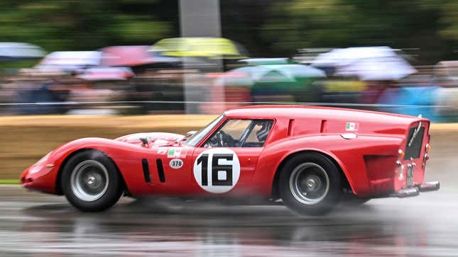 A photo of a vintage Ferrari 250 GT Breadvan racing in the rain. 