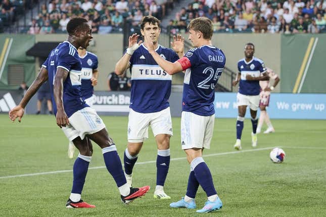 Aug 26, 2023; Portland, Oregon, USA; Vancouver Whitecaps midfielder Ryan Gauld (25) celebrates with teammates after scoring a goal in the first half against the Portland Timbers at Providence Park.