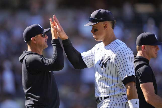 May 28, 2023; Bronx, New York, USA; New York Yankees manager Aaron Boone (17) and right fielder Aaron Judge (99) celebrate the victory against the San Diego Padres after the game at Yankee Stadium.