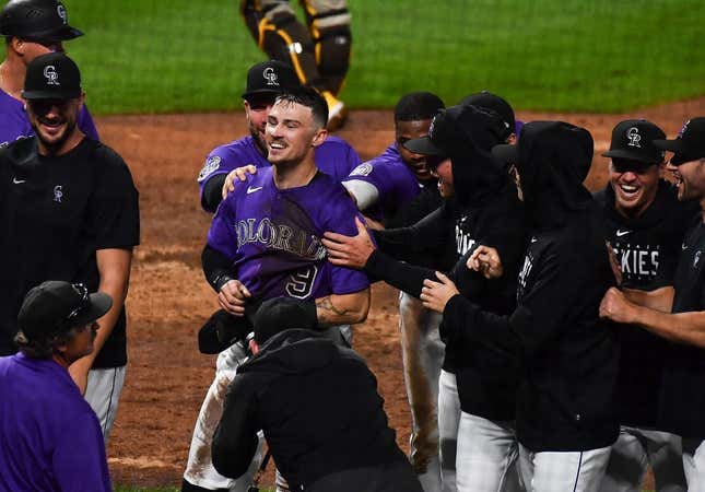 Jul 31, 2023; Denver, Colorado, USA; Colorado Rockies center fielder Brenton Doyle (9) is congratulated by teammates after scoring the winning run in the 10th inning over over the San Diego Padres at Coors Field.