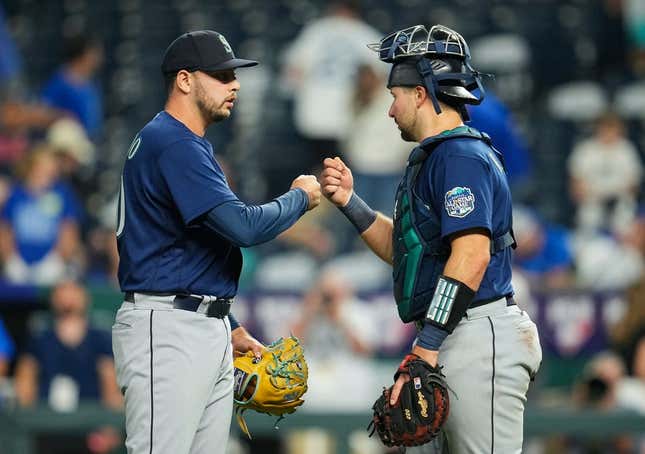 Aug 15, 2023; Kansas City, Missouri, USA; Seattle Mariners relief pitcher Tayler Saucedo (60) celebrates with catcher Cal Raleigh (29) after defeating the Kansas City Royals at Kauffman Stadium.