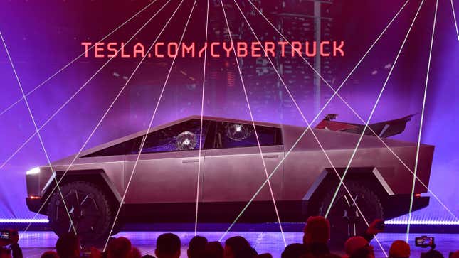People take pictures of the newly unveiled all-electric battery-powered Tesla’s Cybertruck with shattered windows after a failed resistance test on November 21, 2019.