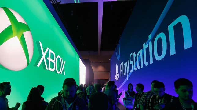 Players walk down an E3 hallway flanked by competing console signs. 