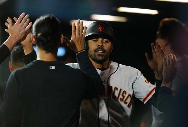Jun 6, 2023; Denver, Colorado, USA; San Francisco Giants first baseman LaMonte Wade Jr. (31) celebrates scoring a run in the seventh inning against the Colorado Rockies at Coors Field.