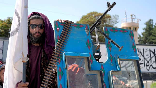 A Taliban fighter poses in front of the U.S. Embassy in Kabul during a celebration marking the first anniversary of the withdrawal of US-led troops from Afghanistan.