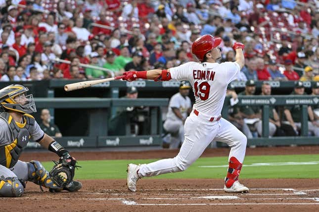Aug 14, 2023; St. Louis, Missouri, USA;  St. Louis Cardinals shortstop Tommy Edman (19) hits one run single against the Oakland Athletics during the second inning at Busch Stadium.