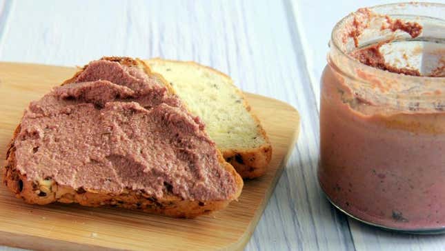 Vegan foie gras (aka faux gras) in glass jar and spread onto baguette