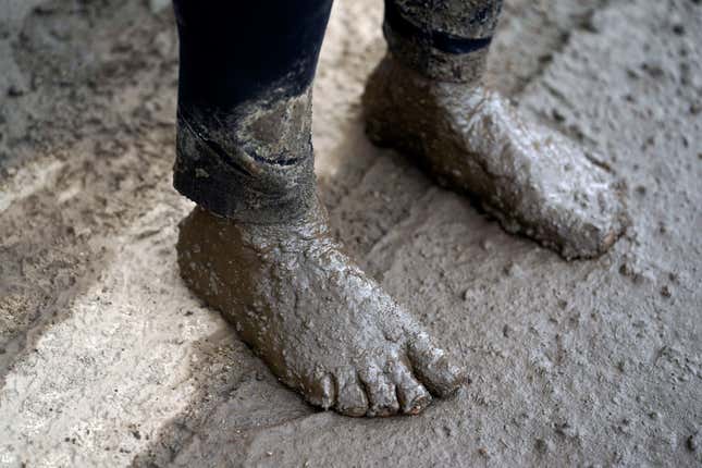Local resident Perla Halbert’s feet, covered in mud after she unsuccessfully tried to reach her property in the aftermath of a mudslide on Tuesday, Sept. 13, 2022, in Oak Glen, California. 