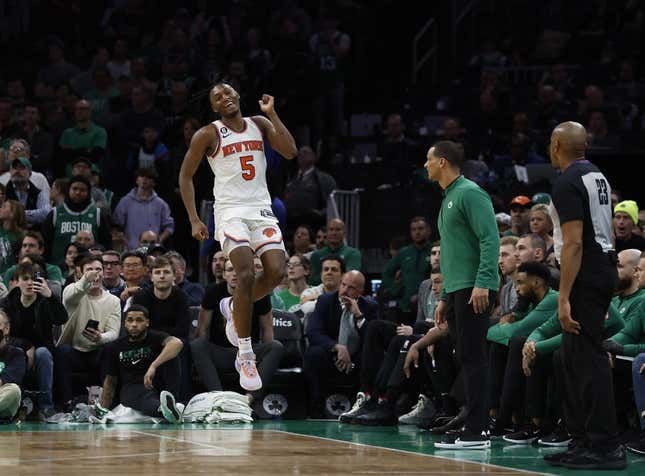 Mar 5, 2023; Boston, Massachusetts, USA; New York Knicks guard Immanuel Quickley (5) celebrates after a basket in front of the Boston Celtics bench during the overtime period at TD Garden.