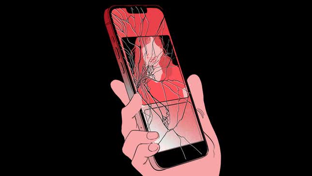 A hand holding a cracked phone displaying a dating app.