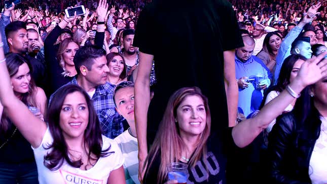 Image for article titled Short Concertgoer Annoyed After Getting Stuck Behind Man Growing Continuously Taller
