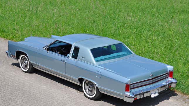 A photo of a pale blue Lincoln Continental sedan. 