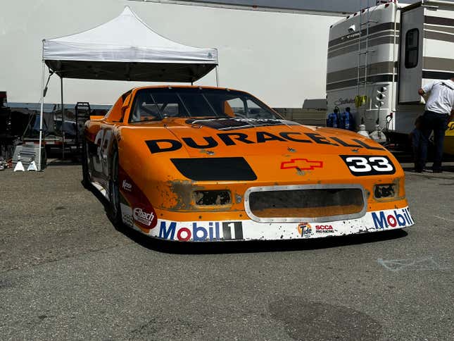 An orange and white Duracell-branded Corvette race car at Laguna Seca