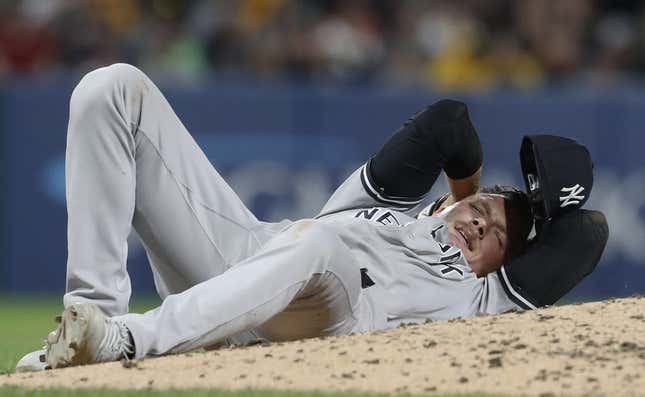 Sep 15, 2023; Pittsburgh, Pennsylvania, USA;  New York Yankees relief pitcher Anthony Misiewicz (54) reacts after being hit in the head by a line drive off the bat of Pittsburgh Pirates second baseman Ji Hwan Bae (not pictured) during the sixth inning at PNC Park. Misiewicz would leave the game.Mandatory Credit: Charles LeClaire-USA TODAY Sports