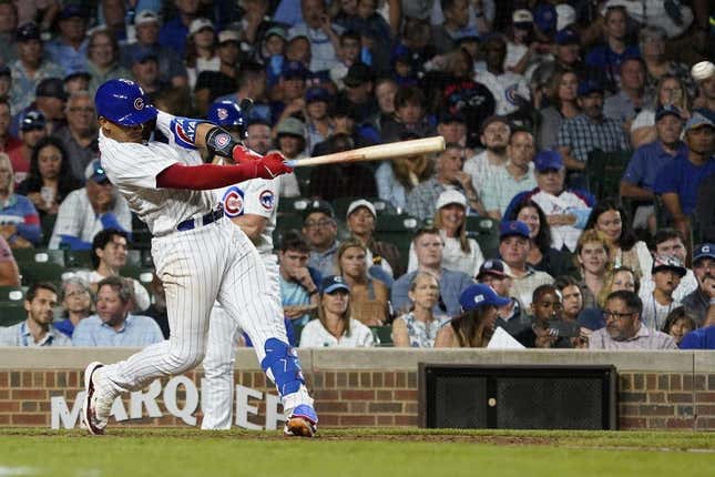 Jul 18, 2023; Chicago, Illinois, USA; Chicago Cubs catcher Miguel Amaya (6) hits a two-run single against the Washington Nationals during the seventh inning at Wrigley Field.