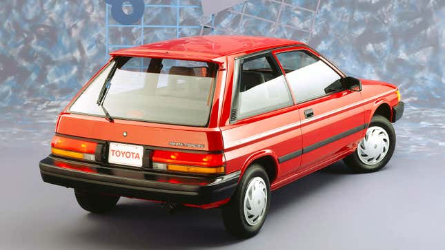 A photo of the rear quarter on a red Toyota Tercel hatchback. 