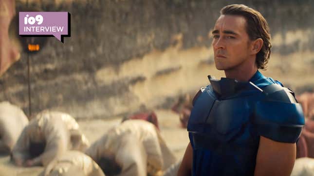 Lee Pace's Emperor/Brother Day/Cleon wears blue armor and stands steel-faced in front of several bowing people in Foundation.