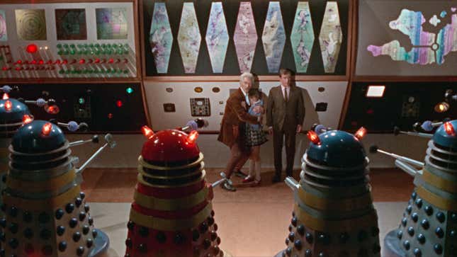 Peter Cushing's Dr. Who, as well as his companions Susan and Ian, are menaced by the Daleks.