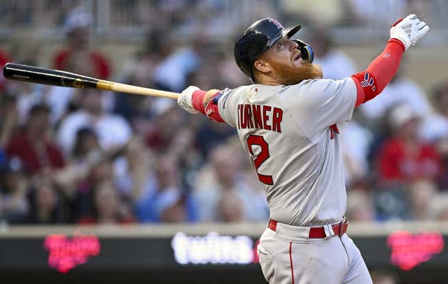 Jun 20, 2023; Minneapolis, Minnesota, USA;  Boston Red Sox designated hitter Justin Turner (2) hits an RBI double against the Minnesota Twins during the seventh inning at Target Field.