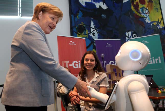 German Chancellor Angela Merkel is introduced to Pepper the Robot by participant Lilly Antonia on Girls’ Day on April 26, 2017 in Berlin, Germany.