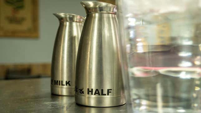 milk and half and half canisters at coffee shop