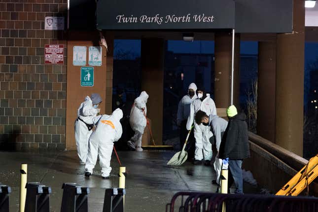 Staffs cleans the floor at the scene of a fatal fire at an apartment building in the Bronx on Sunday, Jan. 9, 2022, in New York.