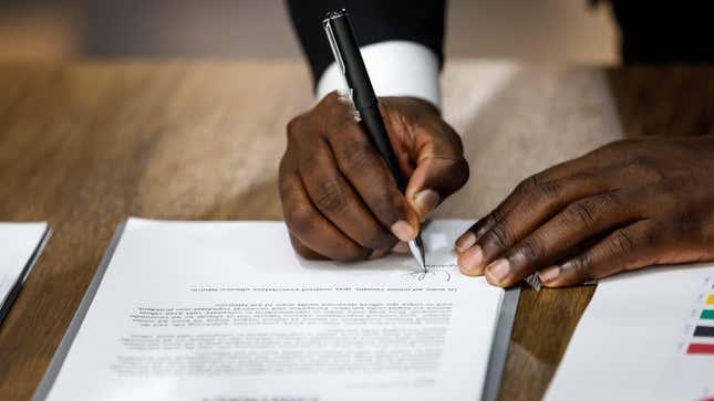 Man in suit signing a contract