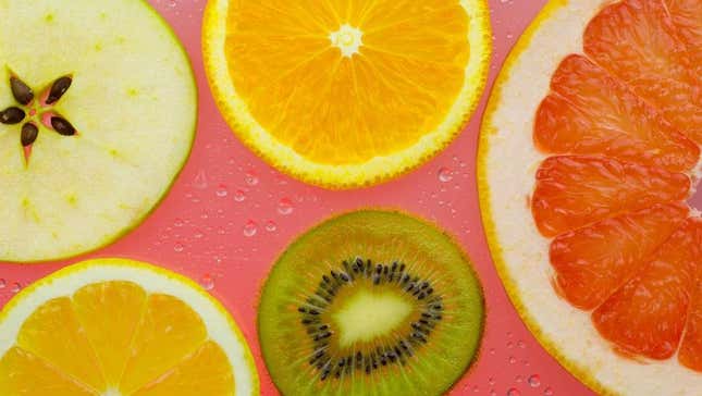 Sliced fruit against carbonated water droplets