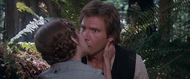 Leia kisses a surprised Han on the forest moon of Endor.