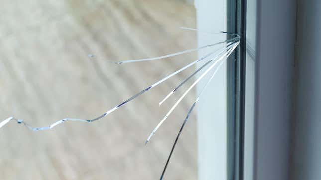A closeup of a cracked window pane in a residential home