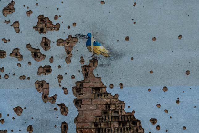 FILE - A dove painted by artist TvBoy adorns the wall of a building damaged by Russian shelling attacks in Irpin, Ukraine, Friday, July 7, 2023. Life in the capital of a war-torn country seems normal on the surface. In the mornings, people rush to their work holding cups of coffee. Streets are filled with cars, and in the evenings restaurants are packed. But the details tell another story. (AP Photo/Jae C. Hong, File)