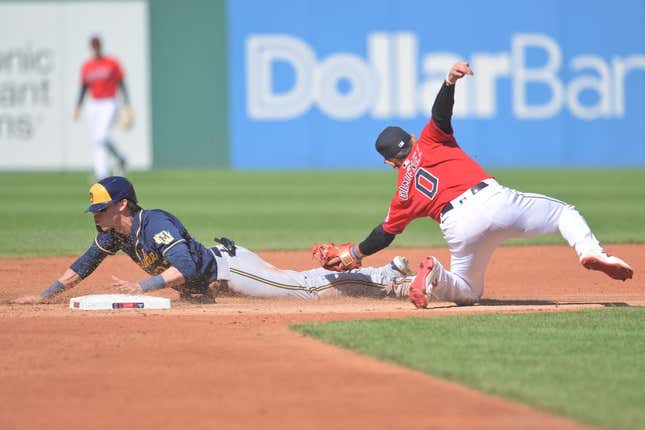 Jun 24, 2023; Cleveland, Ohio, USA; Milwaukee Brewers left fielder Christian Yelich (22) steals second as Cleveland Guardians second baseman Andres Gimenez (0) is late with the tag during the third inning at Progressive Field.
