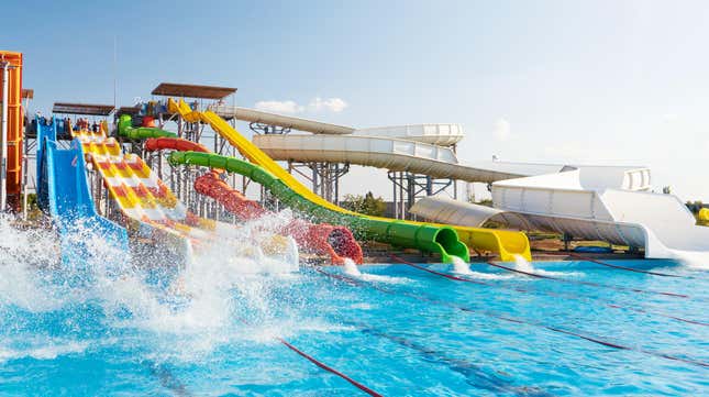 An image of colorful enclosed waterslides at a waterpark 