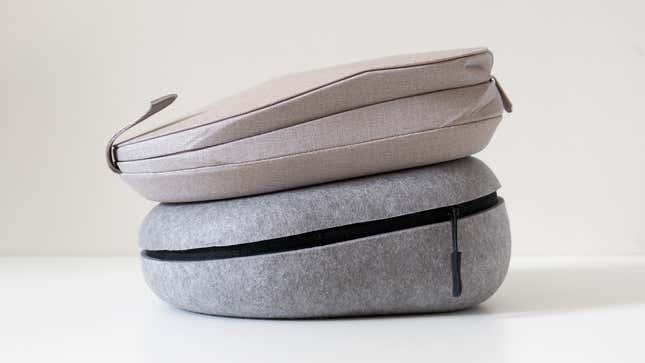 The Master & Dynamic MW75's carrying case sitting underneath the Sony WH-1000XM5's carrying case.