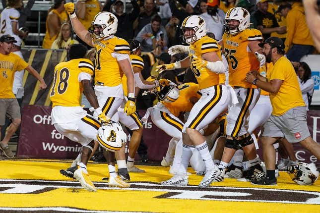Sep 2, 2023; Laramie, Wyoming, USA; Wyoming Cowboys  rush the field after a double overtime win against the Texas Tech Red Raiders at Jonah Field at War Memorial Stadium.