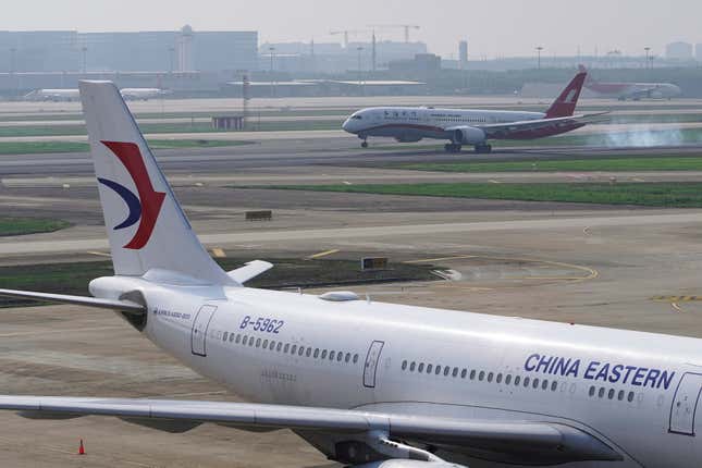 Chinese airlines landing and taking off at an airport.