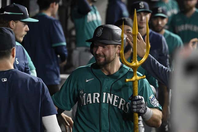 Aug 21, 2023; Chicago, Illinois, USA;  Seattle Mariners catcher Cal Raleigh (29) celebrates in the dugout after he hits a three run home run against the Chicago White Sox during the eighth inning at Guaranteed Rate Field.