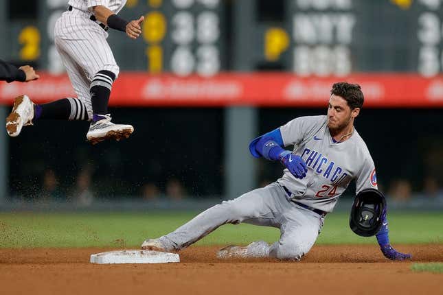 Sep 11, 2023; Denver, Colorado, USA; Chicago Cubs center fielder Cody Bellinger (24) slides into second on a double in the sixth inning against the Colorado Rockies at Coors Field.