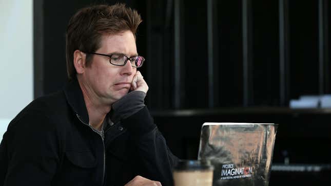 Biz Stone looks down at a laptop and makes a disgusted face.