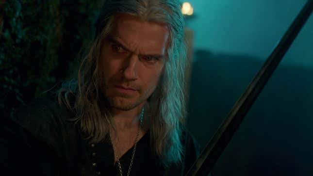 Henry Cavill as Geralt, holding a sword and gazing menacingly off-camera. 
