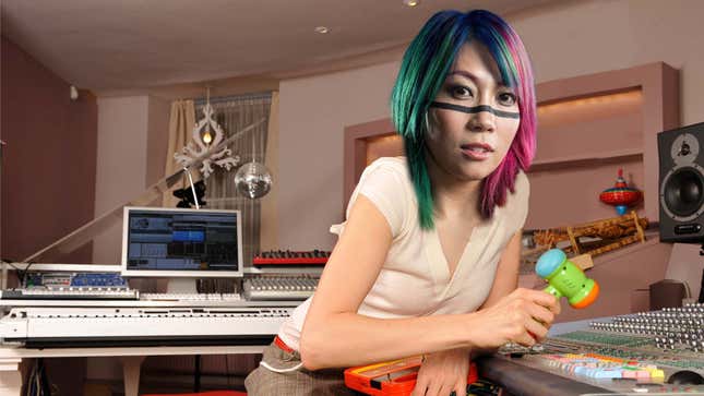 A PhotoShopped Asuka sits in a music studio with a toy hammer in her hand.