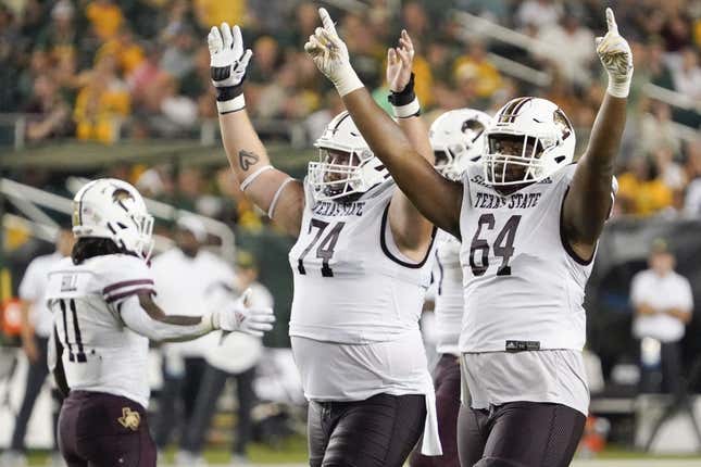 Sep 2, 2023; Waco, Texas, USA; Texas State Bobcats offensive lineman Caleb Johnson (74) and offensive lineman Dorion Strawn (64) celebrate a touchdown against the Baylor Bears during the second half at McLane Stadium.