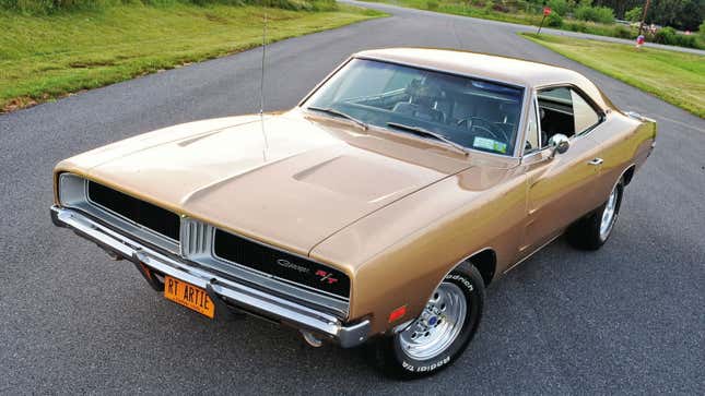 A photo of a gold 1969 Dodge Charger muscle car. 