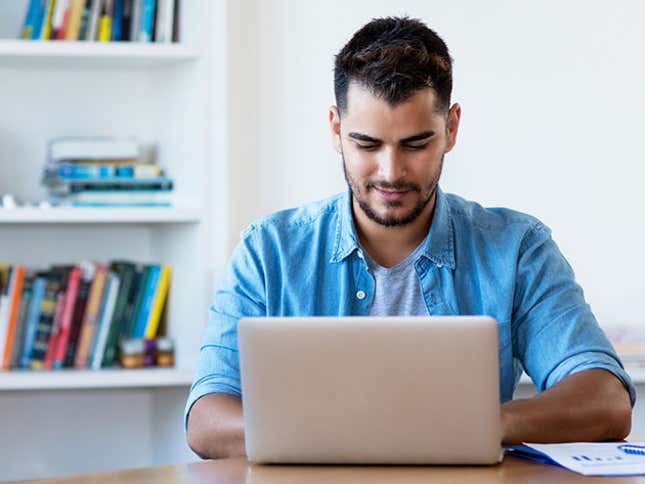 Stock photo tech worker saving time on his job search with a subscription to FlexJobs. 